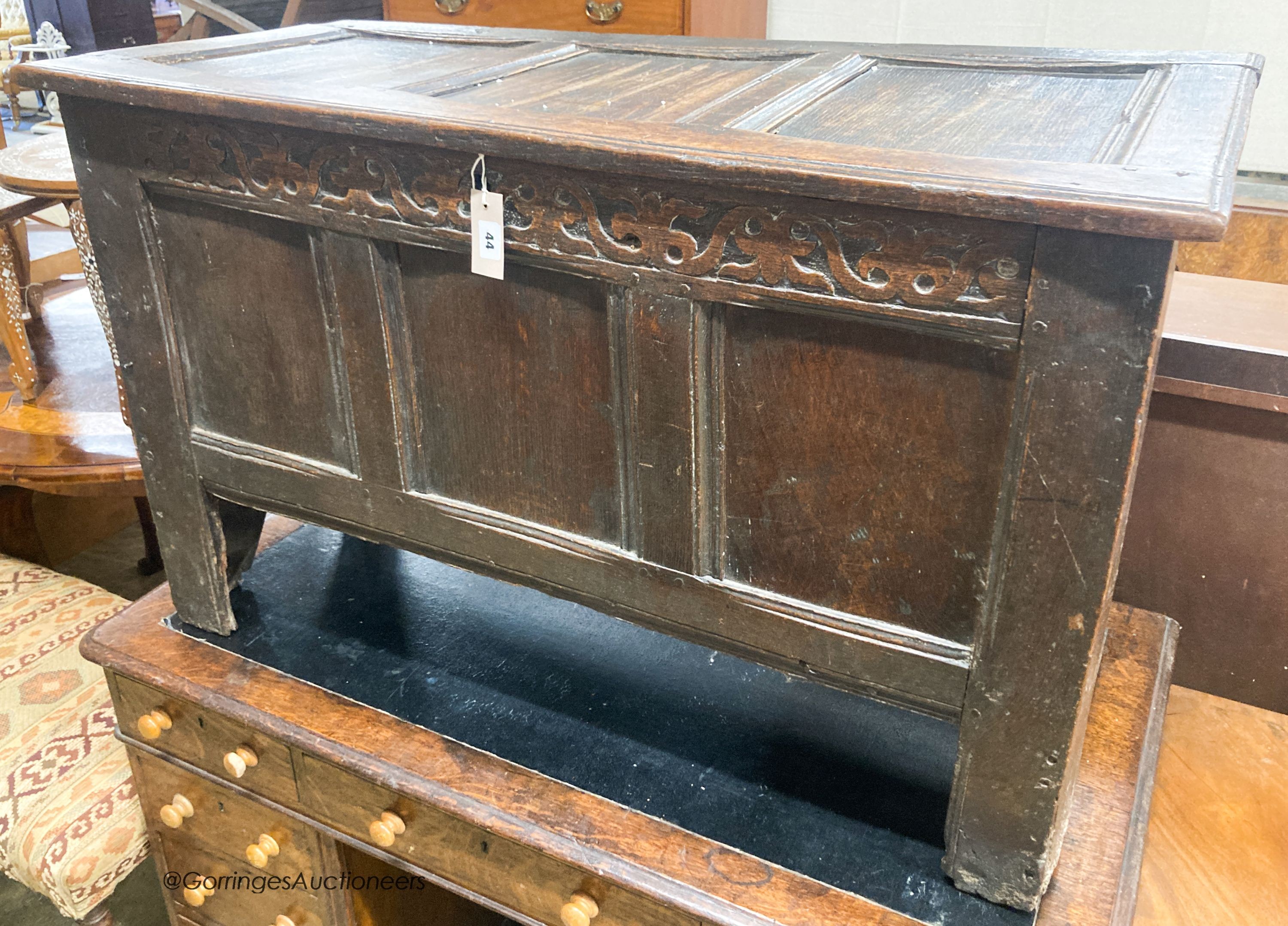 A 17th century caved panelled oak coffer, W.110cm D.48cm H.67cm